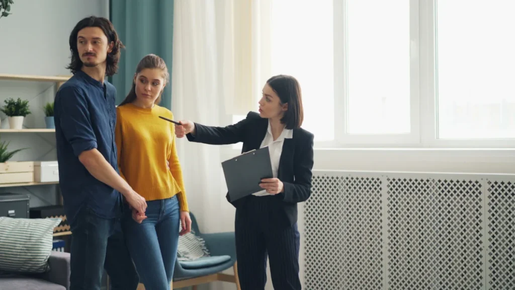 Real Estate CRM and Property Management Software: A Practical Guide 1 Real estate agent showing an apartment to a couple