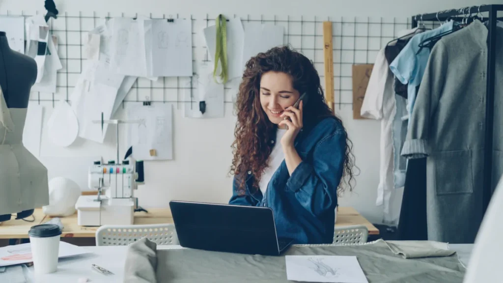 Small business owner working on a laptop in her shop