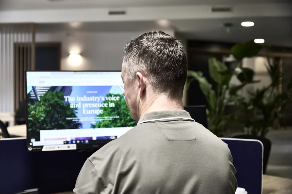 Designer reviewing a website on a desktop monitor
